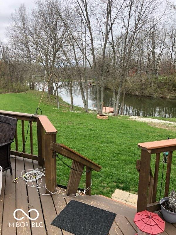 deck featuring a water view and a yard