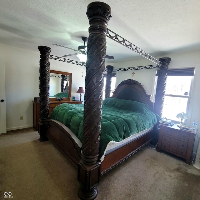 carpeted bedroom with ceiling fan and a textured ceiling