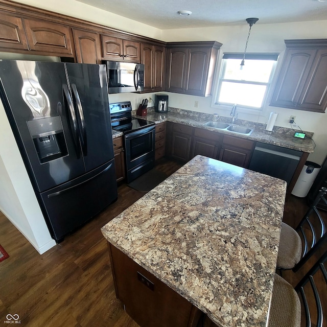 kitchen with black fridge, sink, range with electric cooktop, dark hardwood / wood-style flooring, and light stone counters