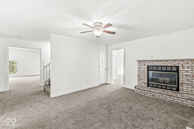 unfurnished living room featuring stairway, baseboards, a fireplace, and carpet flooring