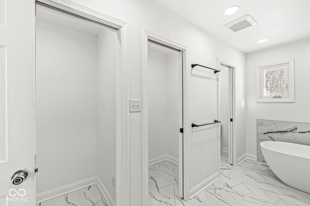 full bath featuring baseboards, visible vents, recessed lighting, a freestanding bath, and marble finish floor