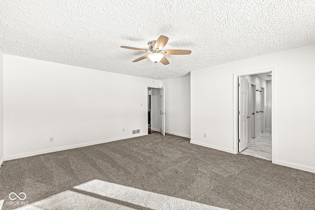 unfurnished bedroom with visible vents, baseboards, a textured ceiling, and carpet flooring