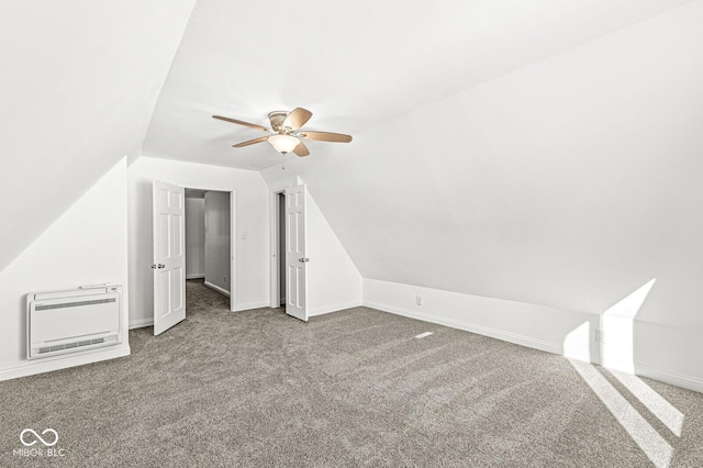 bonus room with heating unit, a ceiling fan, carpet, baseboards, and lofted ceiling