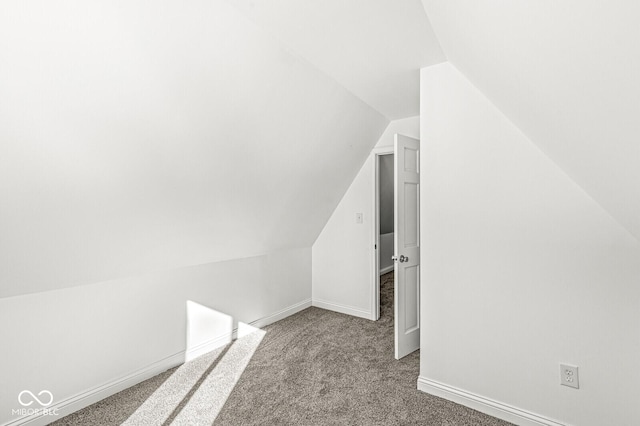 bonus room featuring baseboards, carpet, and vaulted ceiling