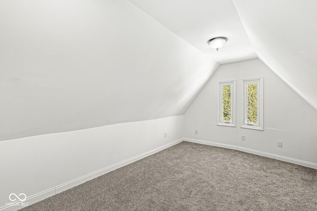 bonus room featuring vaulted ceiling, baseboards, and carpet floors