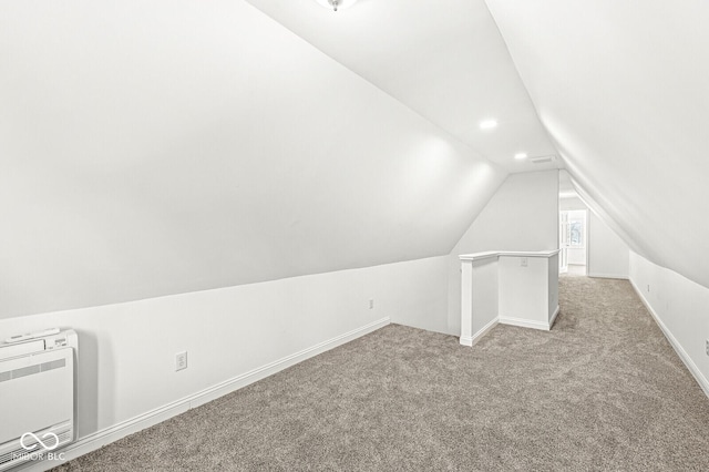 bonus room with baseboards, lofted ceiling, light carpet, recessed lighting, and heating unit