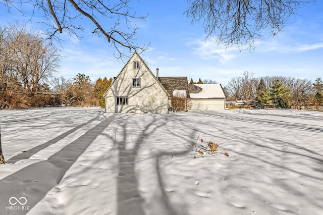 view of snowy exterior with an outbuilding and a barn