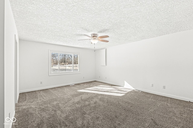 empty room with baseboards, carpet, and a textured ceiling