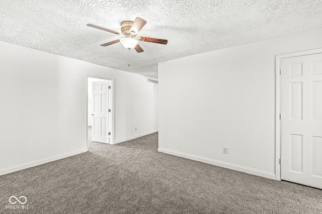 carpeted empty room featuring baseboards, a textured ceiling, and ceiling fan