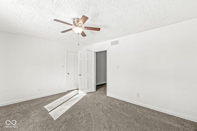 carpeted spare room with visible vents, baseboards, a textured ceiling, and a ceiling fan