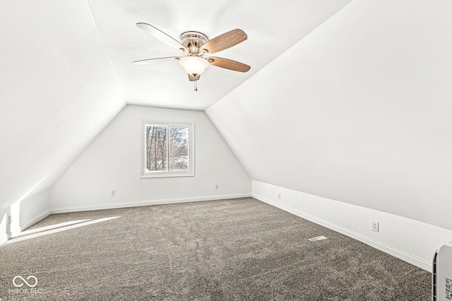 additional living space featuring ceiling fan, baseboards, carpet, and vaulted ceiling