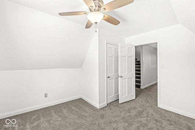 additional living space with baseboards, carpet floors, lofted ceiling, and a ceiling fan