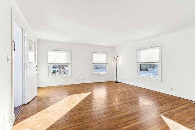 unfurnished room featuring light wood-type flooring and ornamental molding