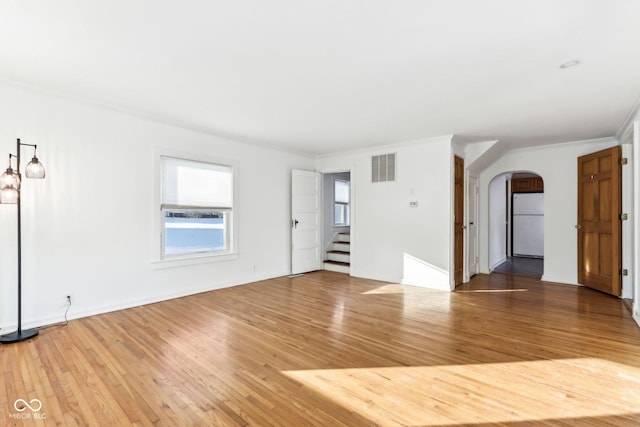 unfurnished room featuring wood-type flooring and crown molding