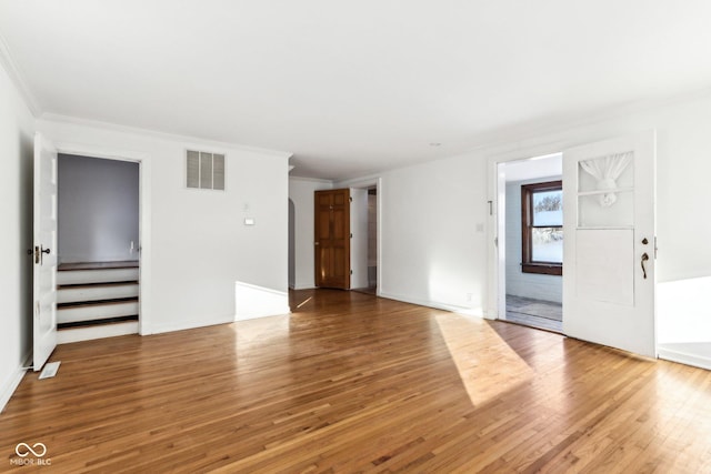 spare room featuring ornamental molding and wood-type flooring