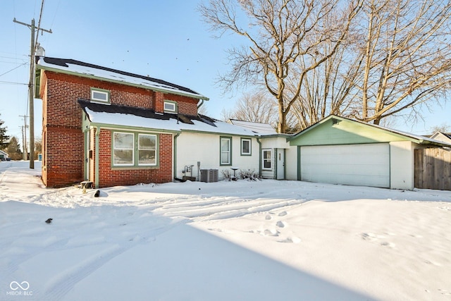 view of front of house with a garage and cooling unit