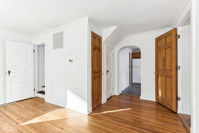 hallway featuring ornamental molding and hardwood / wood-style floors