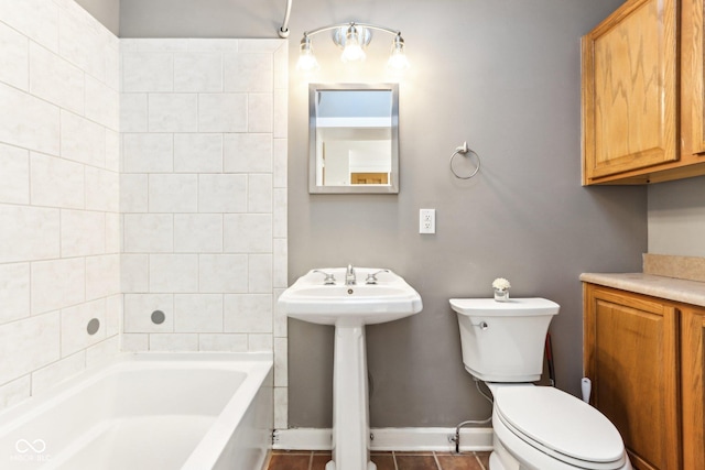 bathroom featuring toilet, tile patterned floors, and sink