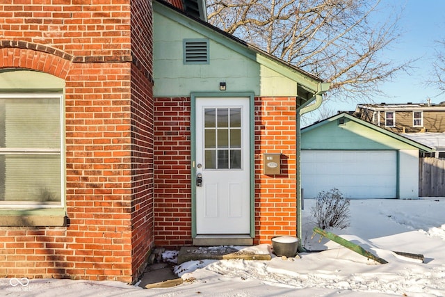 view of snow covered property entrance