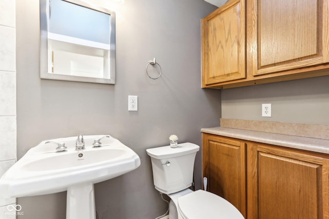 bathroom featuring toilet and sink