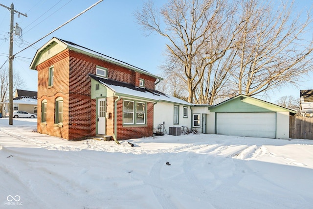 view of front of house with a garage and cooling unit