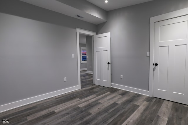 unfurnished bedroom with dark wood-type flooring