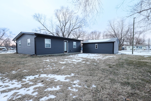 ranch-style home featuring an outbuilding