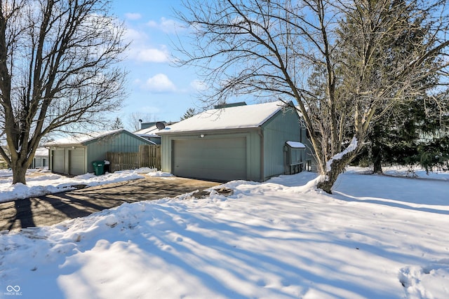 exterior space featuring a garage and an outbuilding