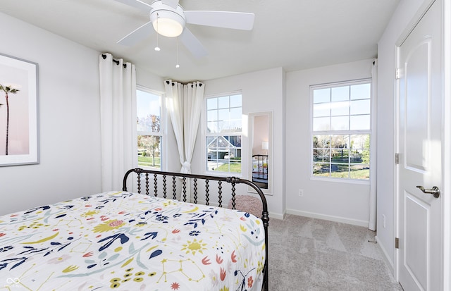 bedroom featuring light colored carpet and ceiling fan