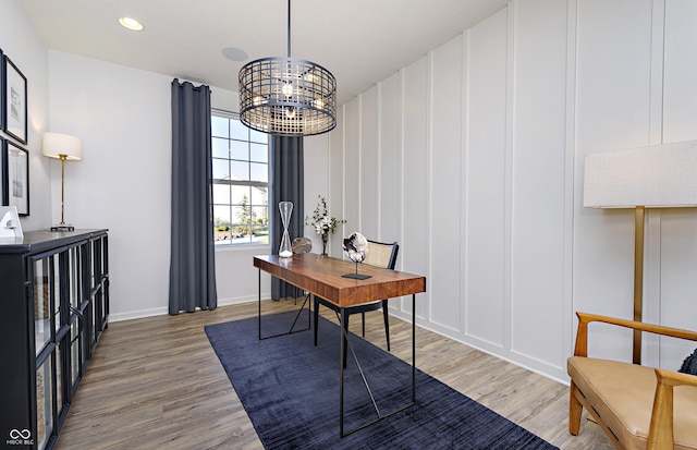 office space with hardwood / wood-style flooring and an inviting chandelier