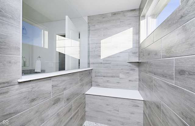 bathroom with tiled shower