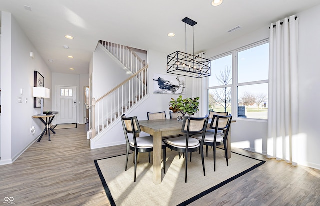 dining room featuring hardwood / wood-style floors and a notable chandelier