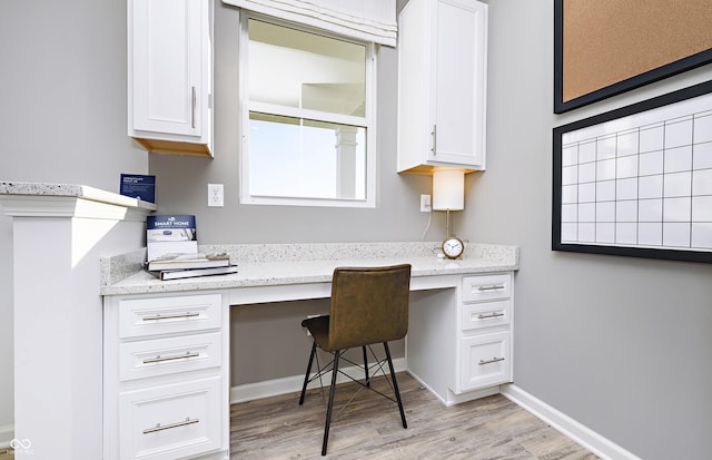 office area featuring built in desk and light wood-type flooring