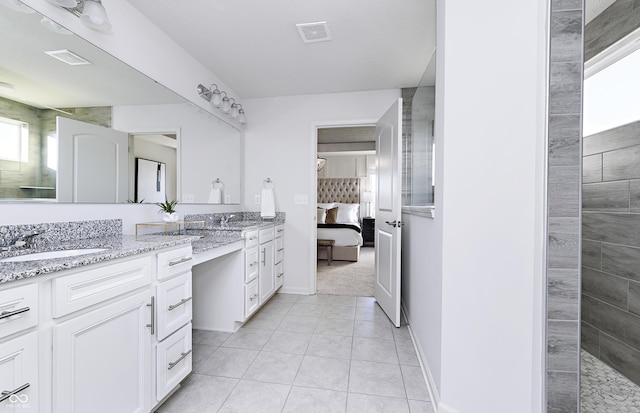 bathroom with tile patterned floors and vanity