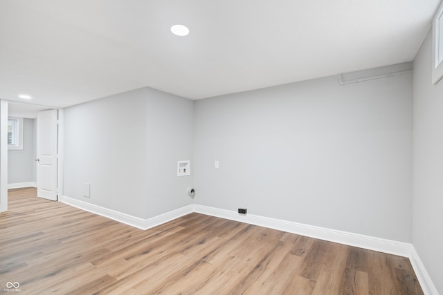 laundry area with electric dryer hookup, hookup for a washing machine, and light wood-type flooring