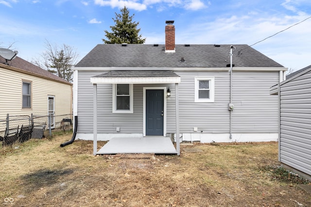 rear view of house with a lawn