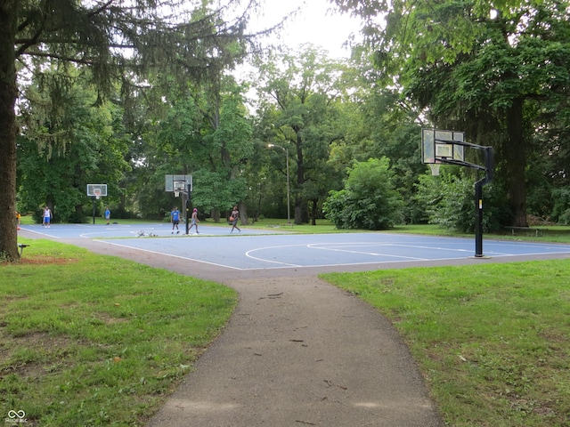 view of sport court featuring a yard