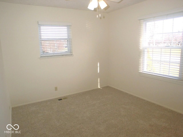 spare room featuring ceiling fan and carpet flooring