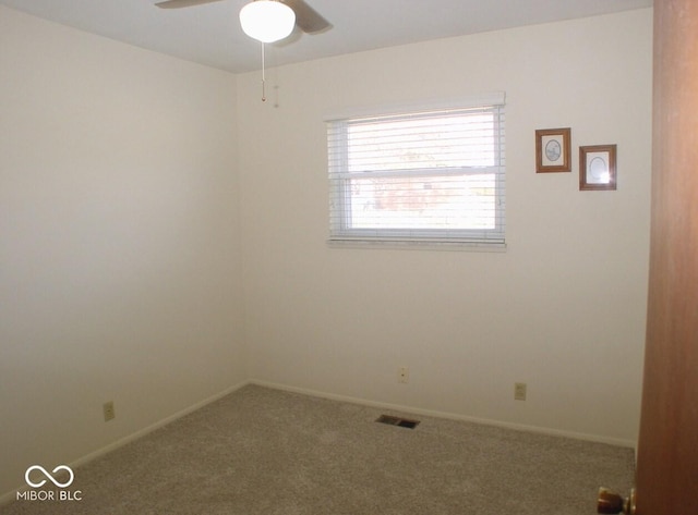 carpeted spare room with ceiling fan