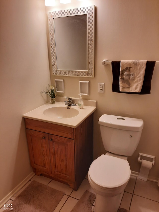 bathroom featuring toilet, tile patterned floors, and vanity