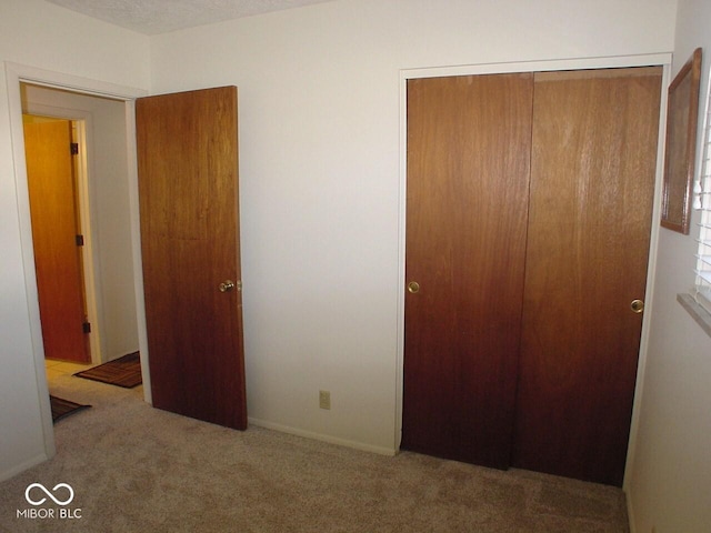 bedroom with carpet and a closet