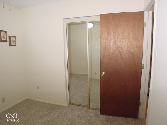 unfurnished bedroom featuring a closet and carpet flooring