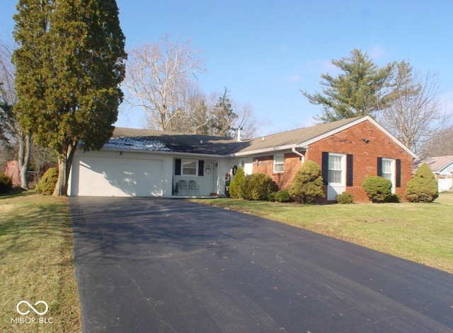 single story home featuring a front lawn and a garage