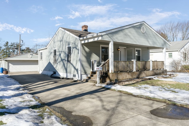 bungalow featuring an outbuilding, a garage, and covered porch