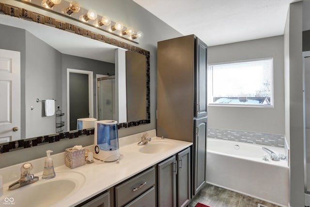 bathroom with vanity, wood-type flooring, and separate shower and tub