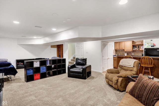 living room with light carpet and bar area