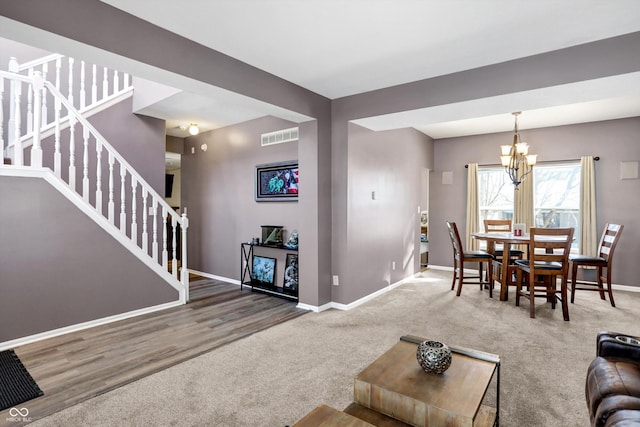 living room featuring carpet floors and a chandelier