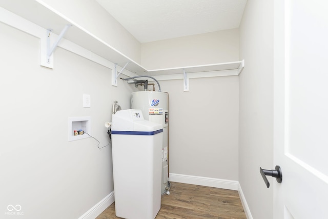 clothes washing area with hookup for a washing machine, hardwood / wood-style floors, and a textured ceiling