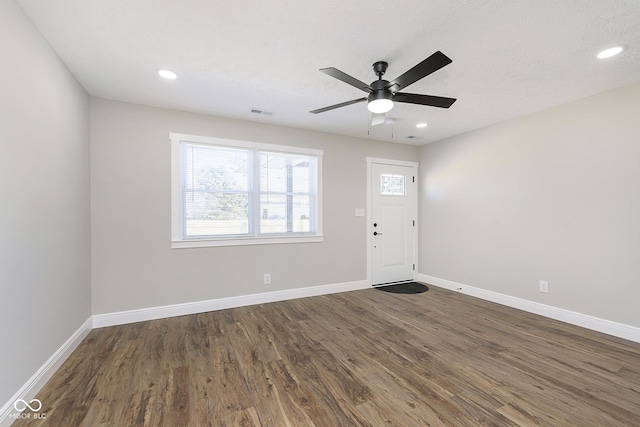 foyer entrance featuring ceiling fan and dark wood-type flooring