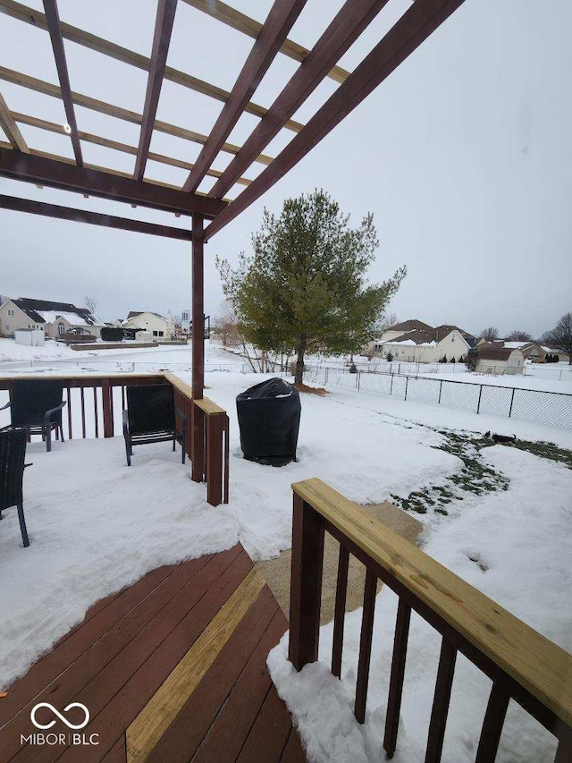 snow covered deck with a pergola